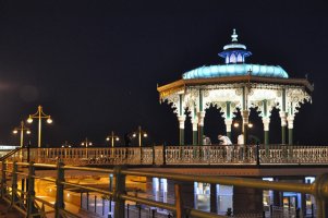 Hove bandstand lit up at night.