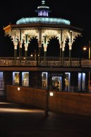 Hove bandstand lit up at night.