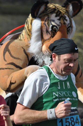 Man running with a tiger behind