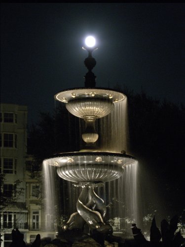 Shining moon on top of a 2 tier fountain in Brighton