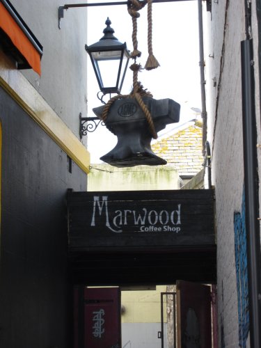 Anvil hanging by a thread above and entrance.