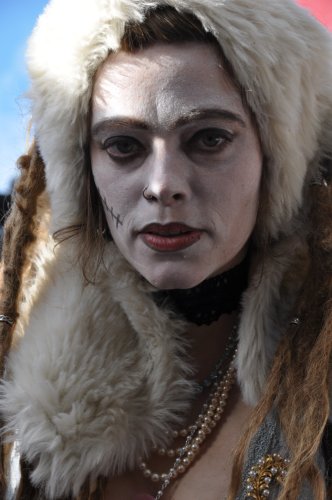 Woman dressed a zombie wearing pearls a fur hat