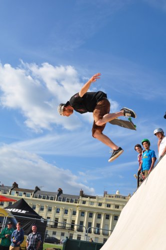 A skate border jumping off a steep ramp